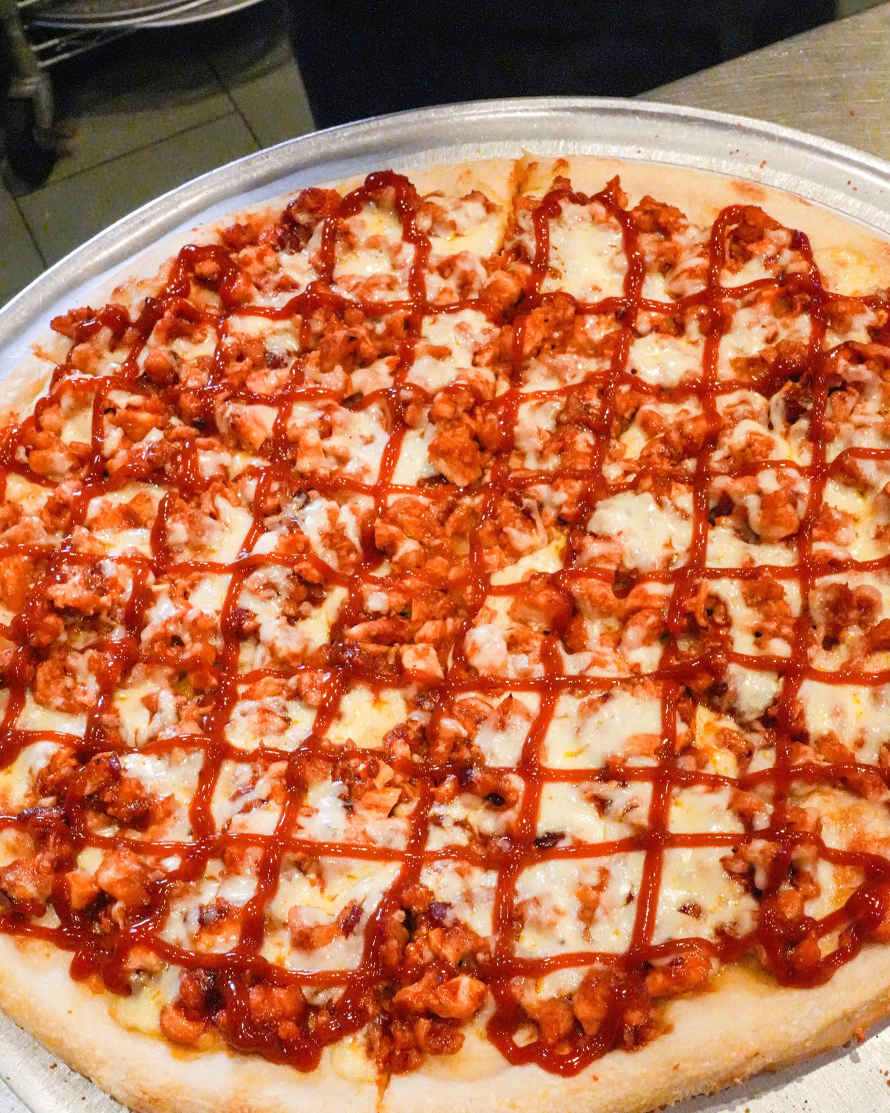 BBQ chicken pie with a crosshatch of sauce