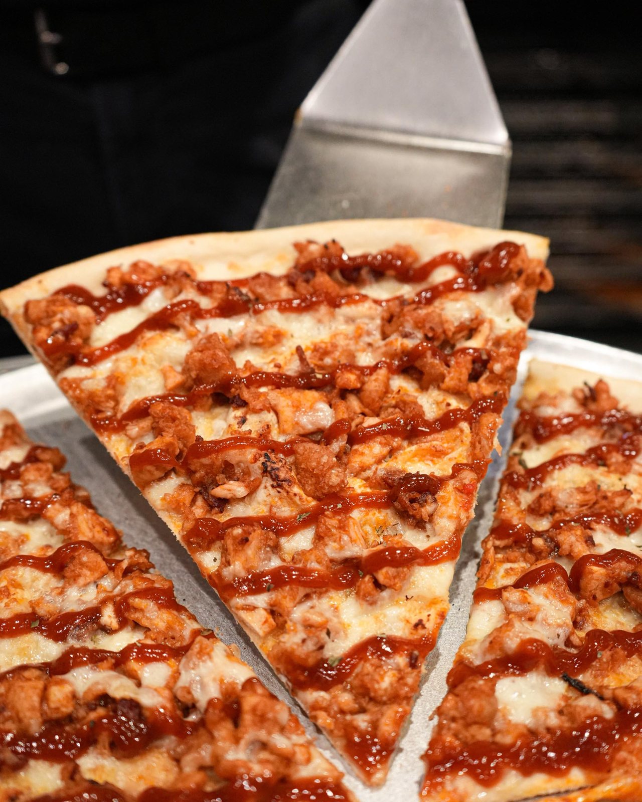 BBQ chicken slice lifted off the pie