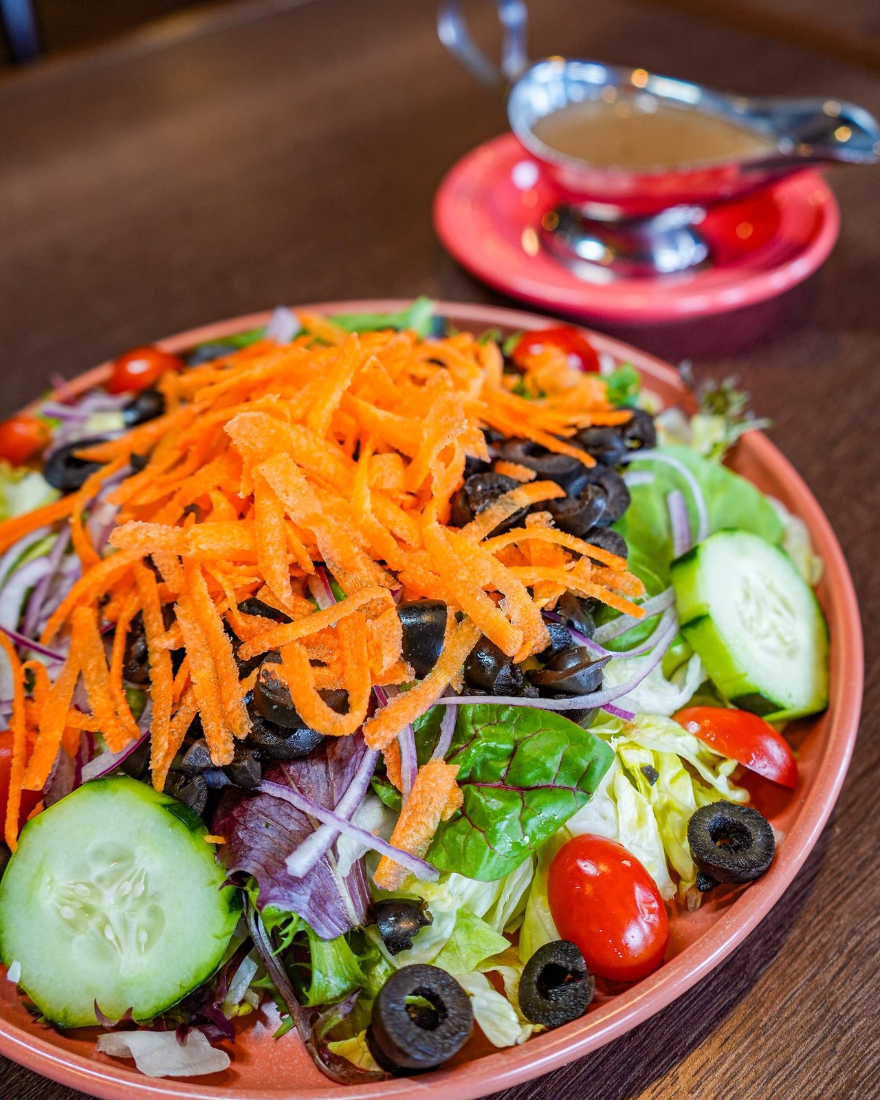 Garden salad with carrots, cucumber and olives