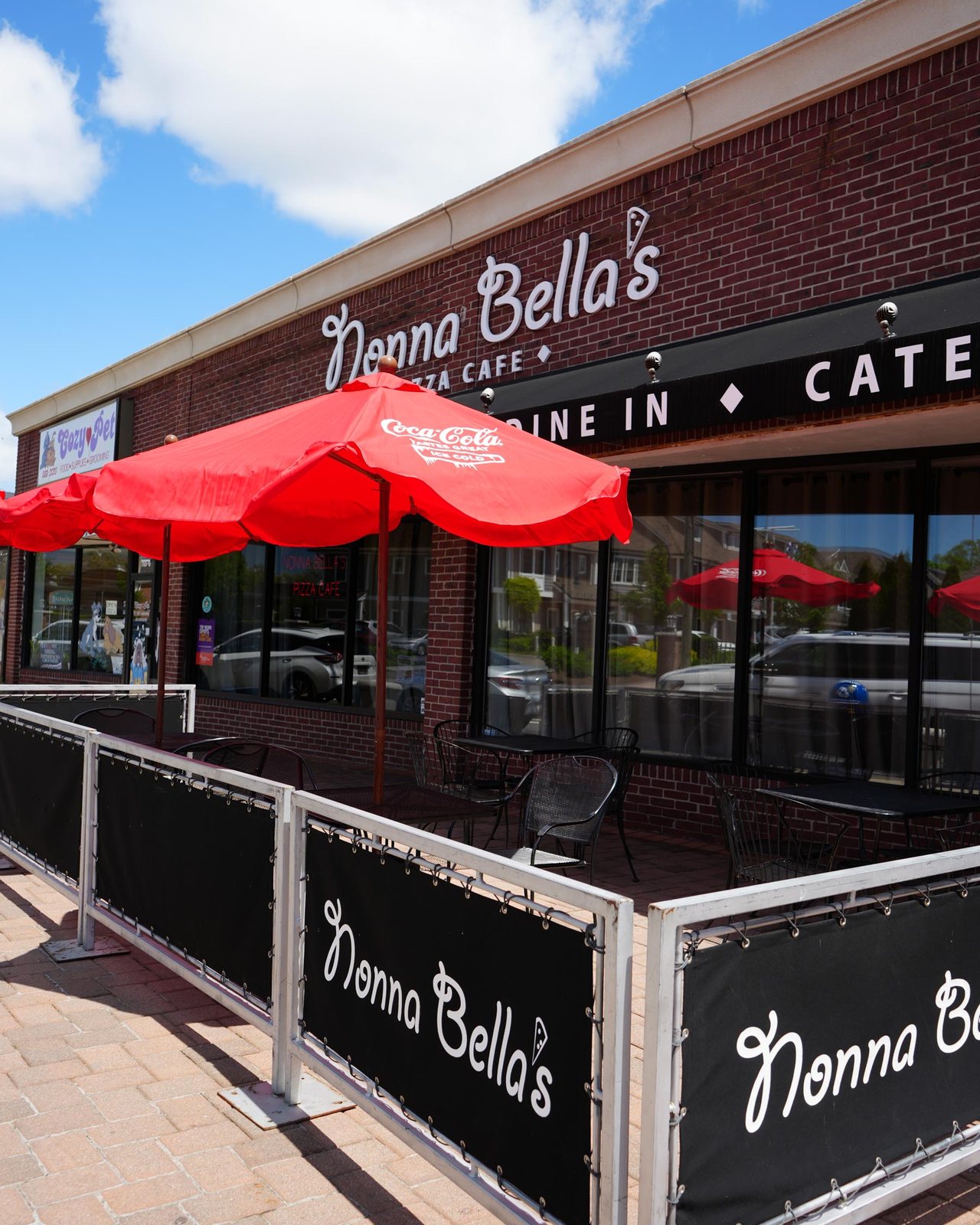 The patio out front, red umbrellas up