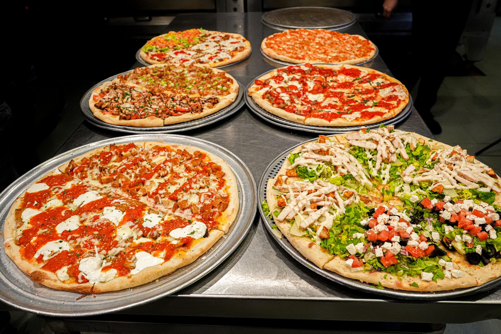 Five pies lined up on the counter