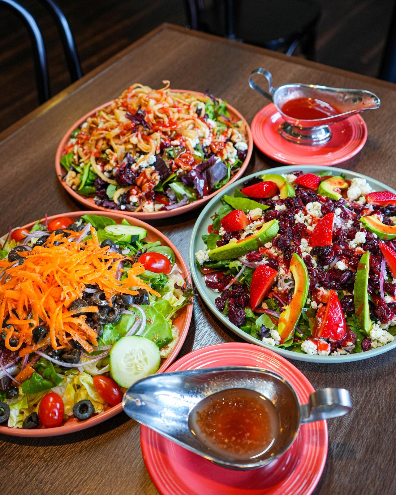 Three salads with dressing on the side