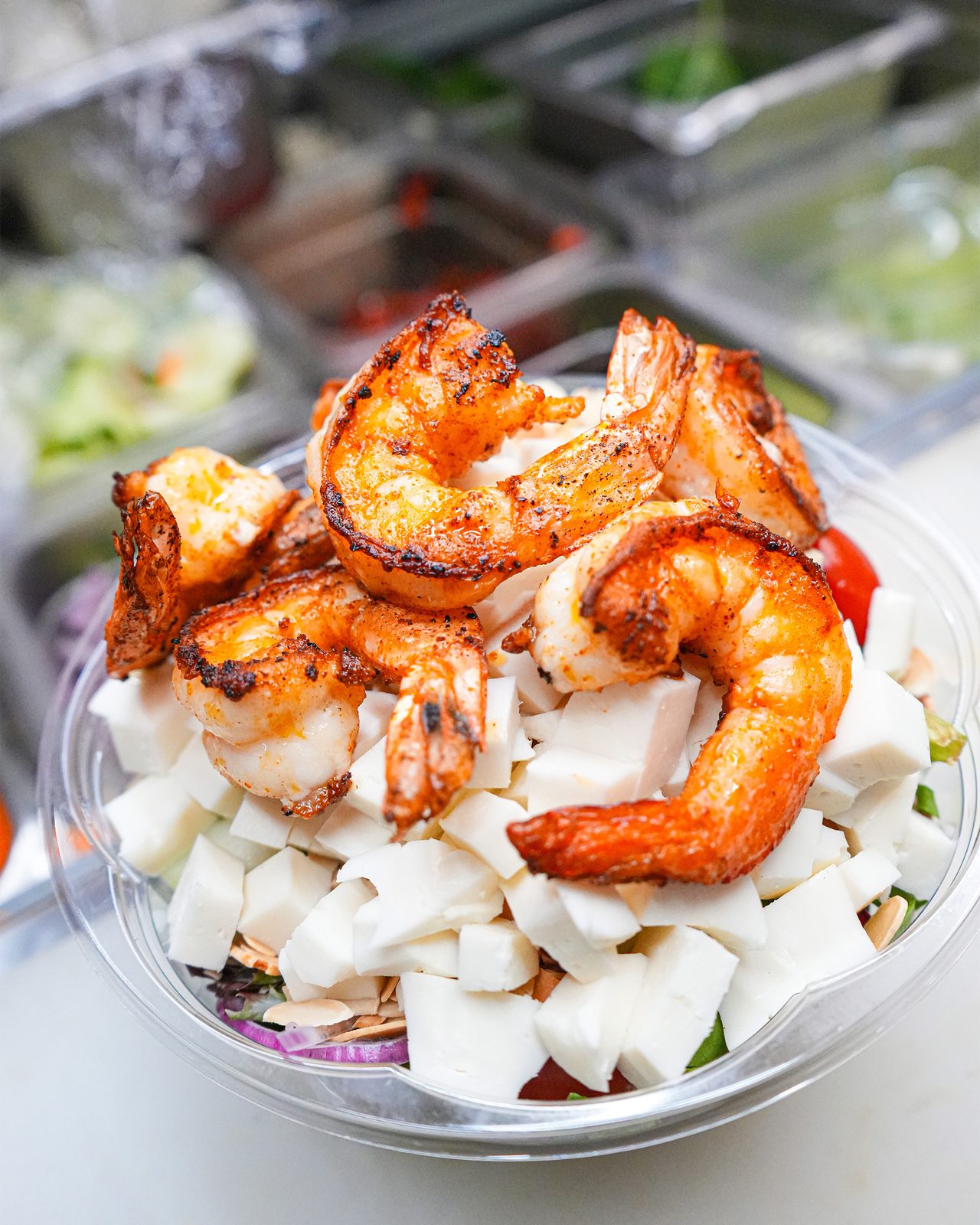 Grilled shrimp over salad